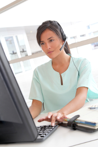 Woman with headset working at computer in office setting
