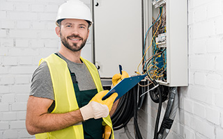 electrical worker installing a security camera