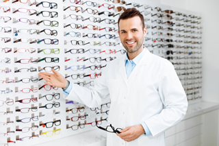 Man showing off wall of glasses