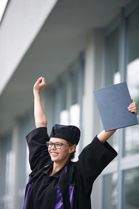 celebrating student in graduation cap and gown