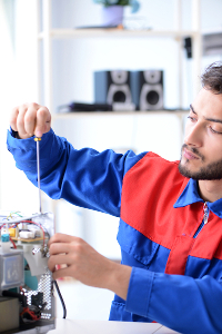 man with beard fixing a small appliance