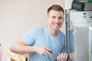 smiling man with screwdriver