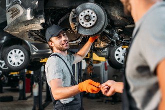 automotive mechanic working under a car