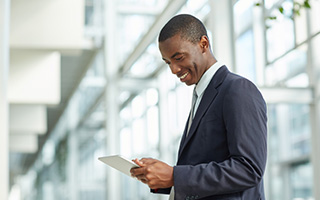 Businessman using tablet in office lobby