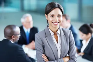 Businesswoman standing in front of colleagues during a business meeting