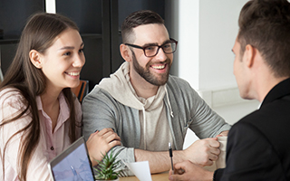 Two men and a woman in a business meeting.