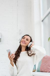 Happy woman listening to headphones