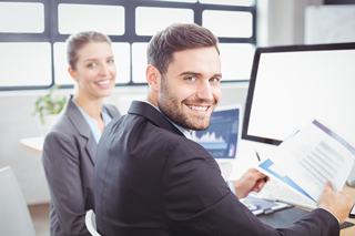 male and female business professionals working together at a desk