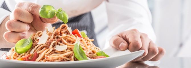 Chef in a culinary school demonstrating plating