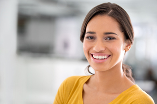 Young woman in yellow blouse in a bright modern room