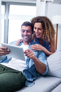 Couple on a couch working from home