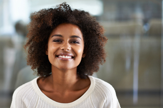Portrait of a Young woman with curly hair in a white sweater