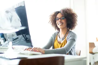 Woman using a computer in a bright office setting