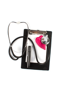 A stethoscope and a clipboard with a pen and a red heart shape, isolated on a white background.