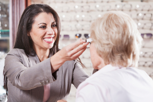 Optician helping a lady find glasses