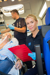 Smiling paramedic in an ambulance