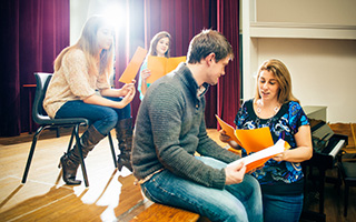 Group of young adults engaged in a script reading session in a bright room