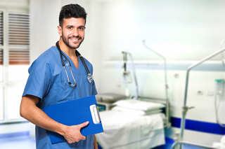 RN in blue scrubs with a stethoscope holding a clipboard in a hospital room.