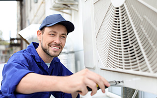 HVAC technician working on a fan